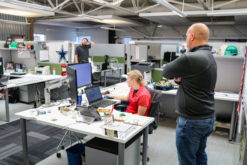 Nucor Detailing Center Employees reviewing CAD drawing.